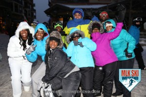 MLK Ski Weekend 2016 group photo of ladies posing outside in winter gear during night time in the village