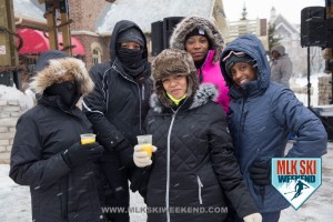MLK Ski Weekend 2016 group photo of ladies posing outside in winter gear having a drink in the village