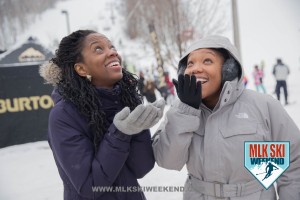 MLK Ski Weekend 2016 photo of ladies trying to catch real snow in the village during day party